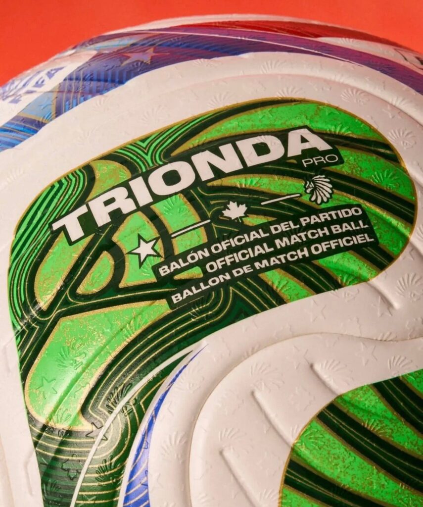 FIFA Trionda official match ball for 2026 World Cup showing red, green, and blue design with maple leaf, eagle, and star symbols representing Canada, Mexico, and United States